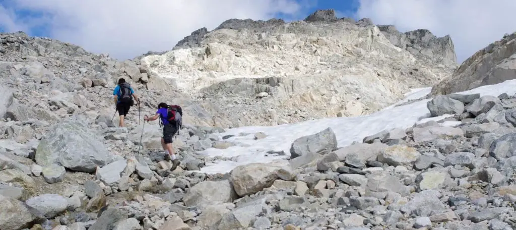 Hiking up the rocky peak of a mountain - What Does Scramble Mean in Hiking