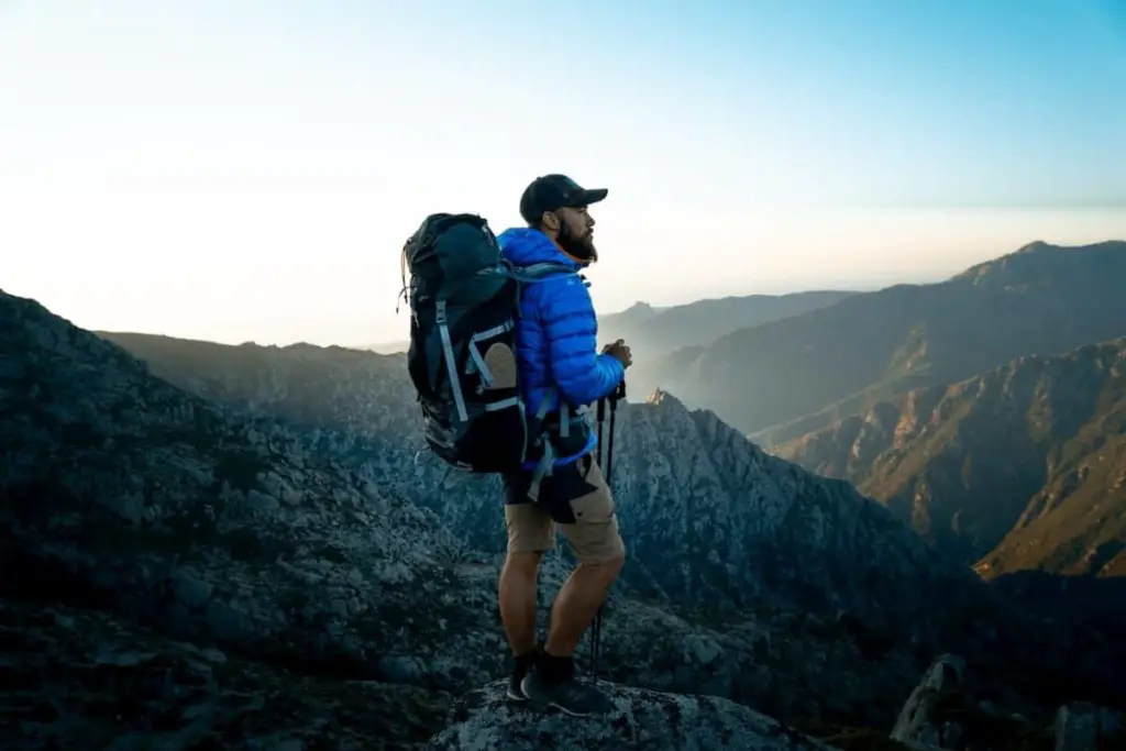 Man Hiking out on the hilltop peak - post on the Average Thru Hike Miles Per Day